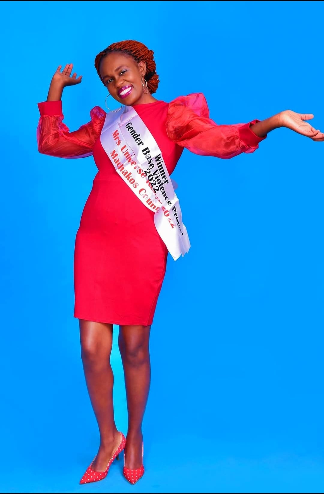 Founder of Brighter Bolder Beginnings standing confidently in a red dress.